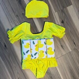 Adorable yellow duck baby onesie featuring a cute white duck and leaf print